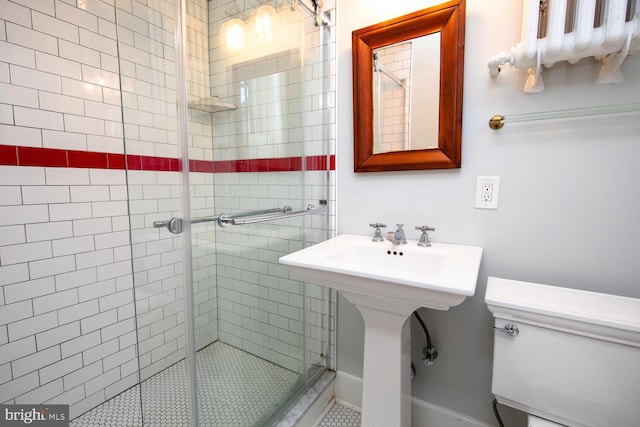 bathroom featuring a shower stall and toilet