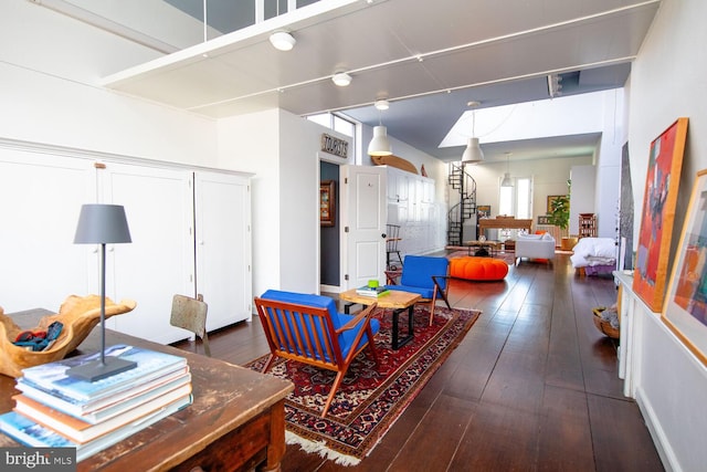 living area featuring wood-type flooring and stairs