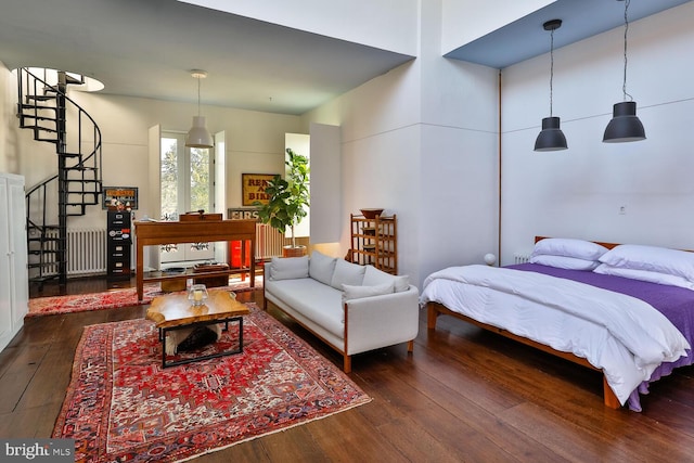 bedroom featuring radiator heating unit and wood-type flooring