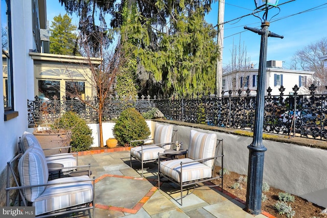 view of patio featuring fence