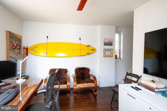 office space featuring wood finished floors, a ceiling fan, and baseboards