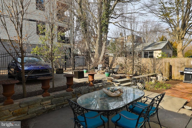 view of patio / terrace with outdoor dining area, fence, and grilling area