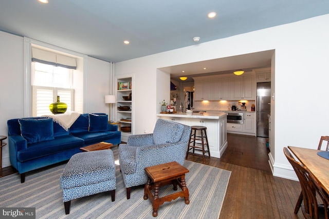 living area featuring dark wood-style floors and recessed lighting