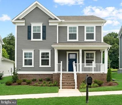 view of front of property with a porch and a front yard