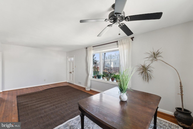 dining room featuring wood finished floors and baseboards