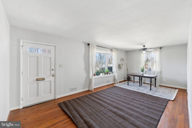 entrance foyer with wood-type flooring, visible vents, and baseboards