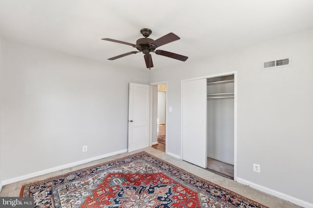 carpeted bedroom featuring a ceiling fan, baseboards, visible vents, and a closet