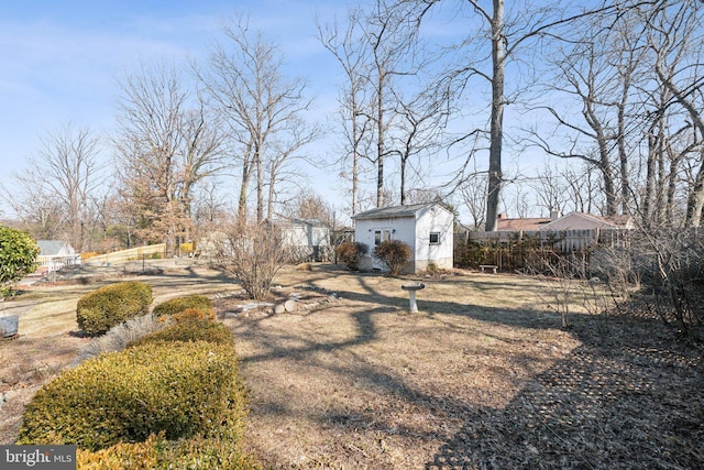 view of yard with an outdoor structure and fence