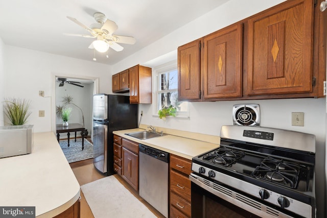 kitchen featuring visible vents, stainless steel appliances, a sink, and light countertops