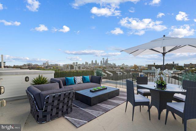 view of patio / terrace featuring outdoor dining area, outdoor lounge area, and a city view