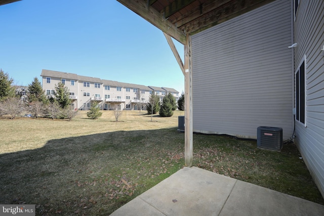 view of yard with a patio, central air condition unit, and a residential view