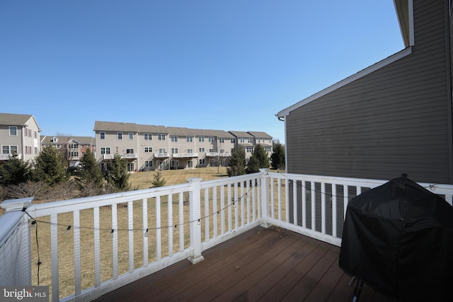 deck featuring a residential view and grilling area