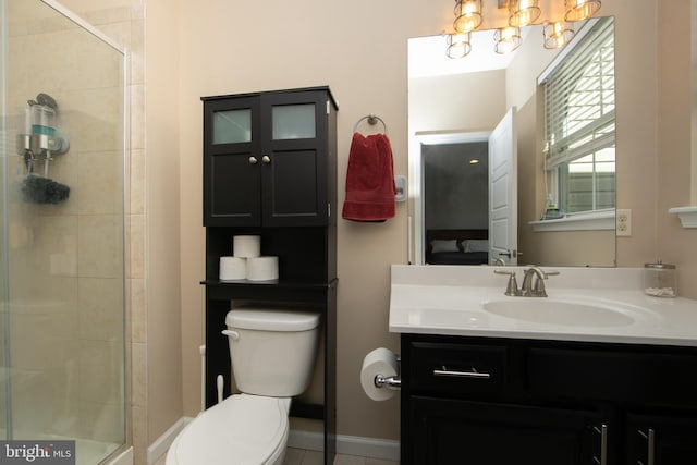 ensuite bathroom featuring a tile shower, vanity, toilet, and ensuite bathroom