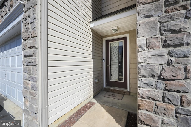 property entrance with stone siding