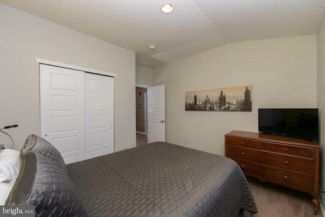 bedroom featuring a closet, carpet flooring, and lofted ceiling