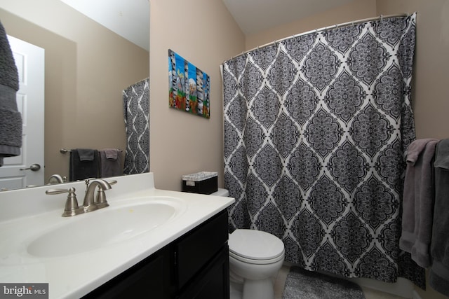 bathroom featuring toilet and vanity