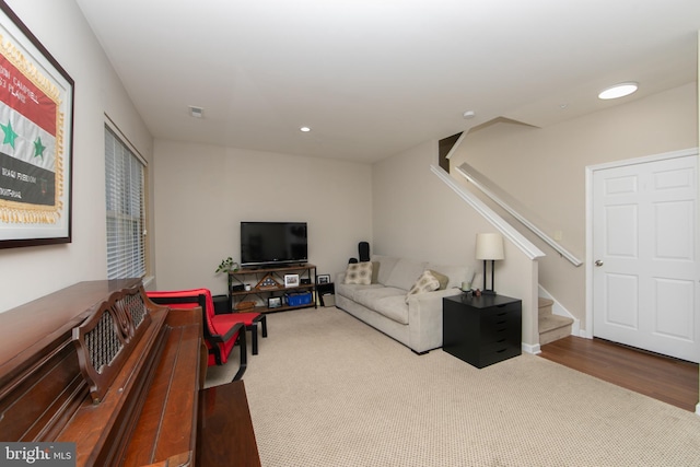 living room with recessed lighting, stairway, carpet floors, and wood finished floors