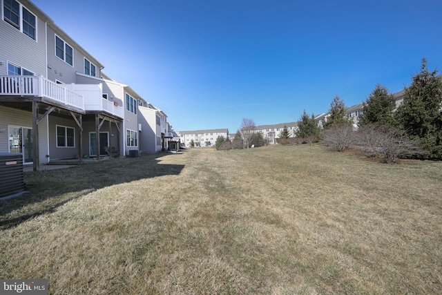 view of yard with a residential view and central AC