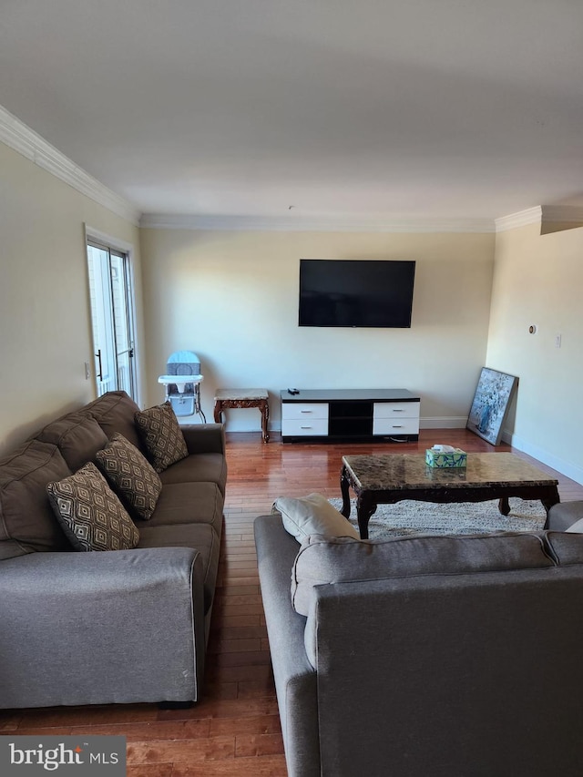 living room with baseboards, ornamental molding, and hardwood / wood-style floors