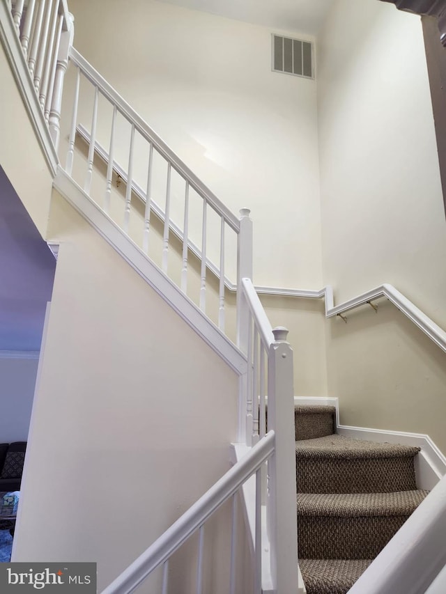 staircase featuring visible vents