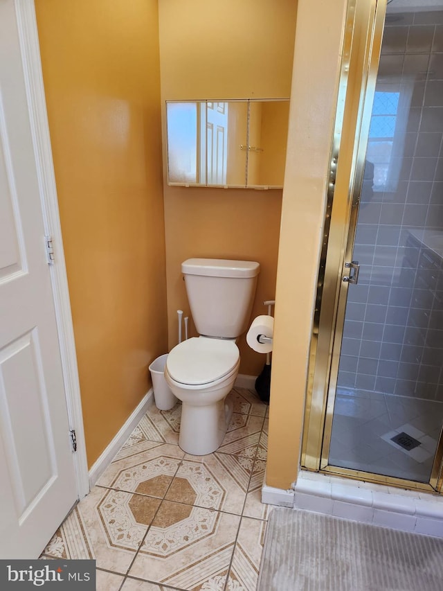 full bathroom featuring tile patterned flooring, baseboards, a shower stall, and toilet