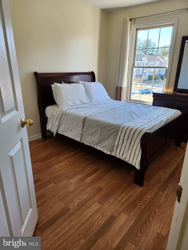 bedroom with wood finished floors and baseboards