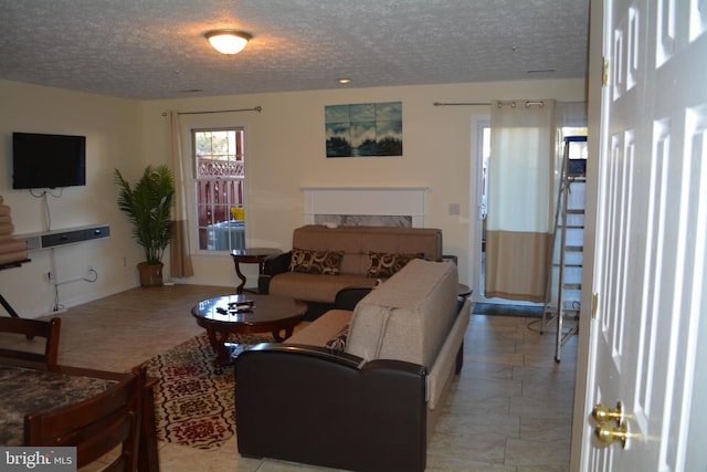 living area with a textured ceiling