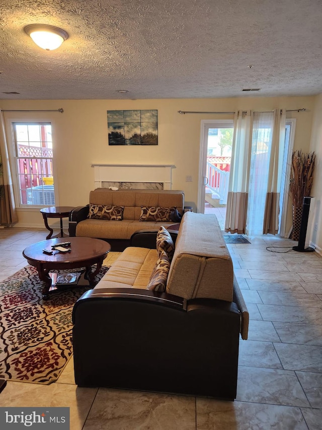 living area with a healthy amount of sunlight and a textured ceiling