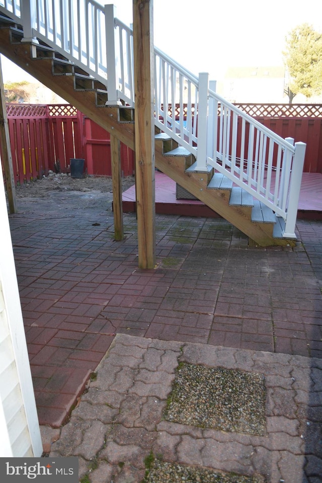 view of patio / terrace featuring stairway and fence