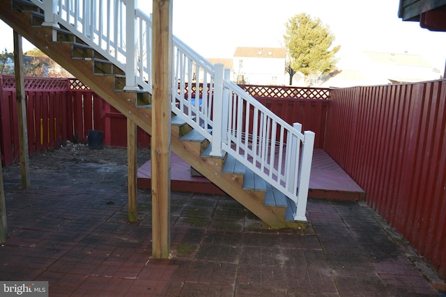 deck featuring a patio area, a fenced backyard, and stairway