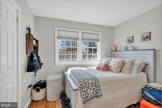 bedroom with baseboards and wood finished floors