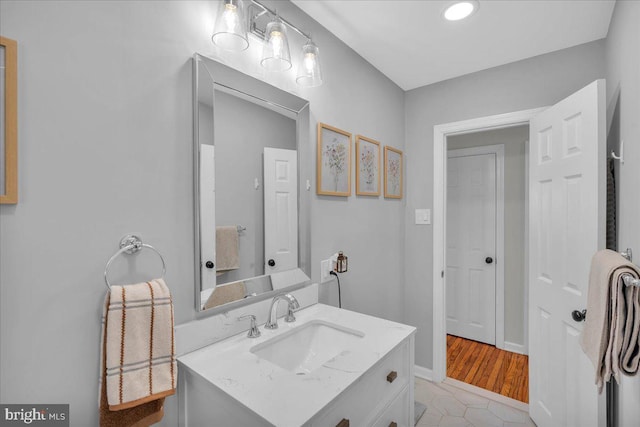 bathroom featuring baseboards and vanity