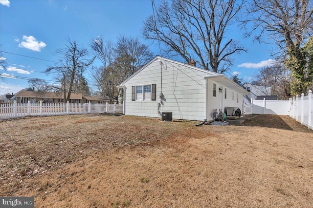 exterior space with a lawn and a fenced backyard