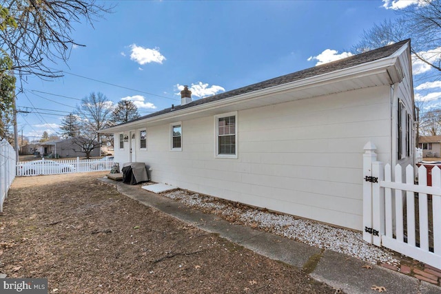 view of side of property featuring a fenced backyard