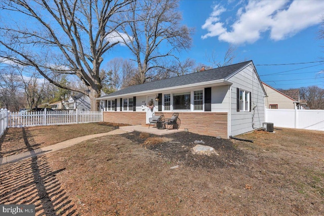 single story home with a fenced backyard, cooling unit, and a front yard