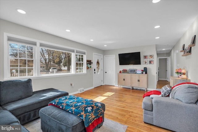 living room with attic access, baseboards, visible vents, wood finished floors, and recessed lighting