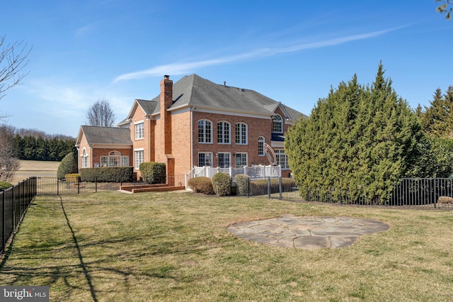 rear view of property featuring a chimney, fence, and a lawn