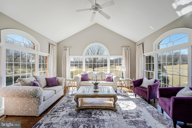 sunroom with vaulted ceiling and a ceiling fan