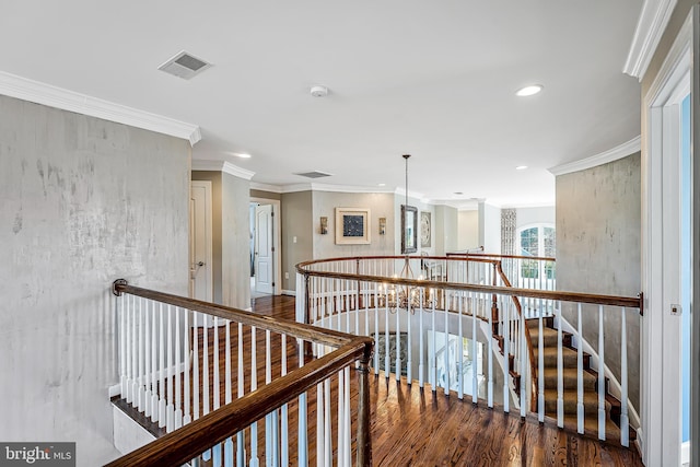 hall with visible vents, ornamental molding, wood finished floors, an upstairs landing, and recessed lighting