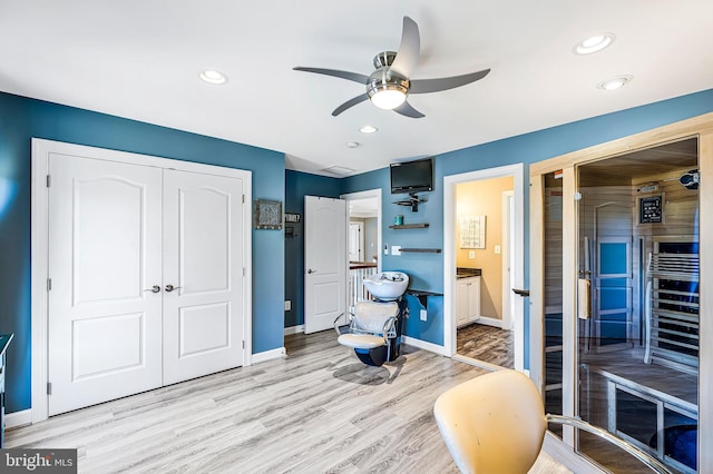 sitting room featuring light wood-type flooring, a sauna, baseboards, and recessed lighting