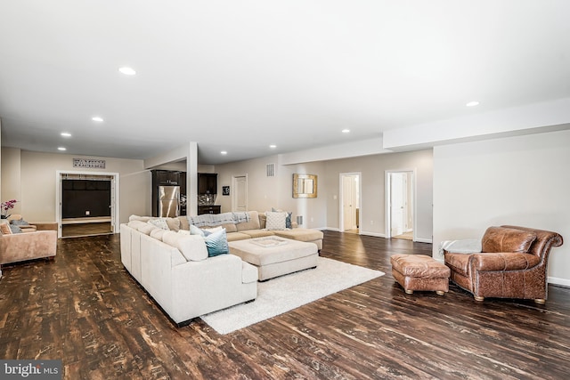 living room featuring dark wood-style floors, recessed lighting, and baseboards