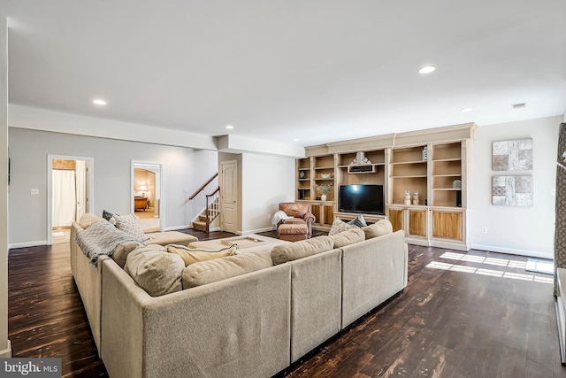 living room with visible vents, baseboards, wood finished floors, stairs, and recessed lighting