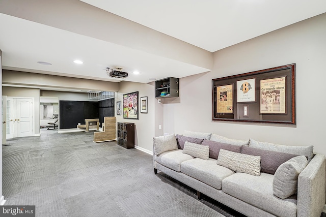 carpeted living area with recessed lighting and baseboards