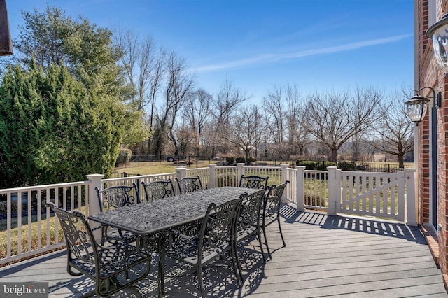 wooden terrace with outdoor dining area