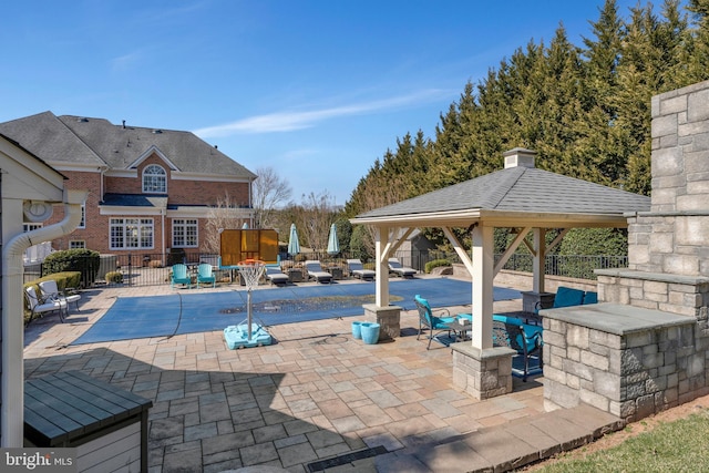 view of pool featuring a gazebo, a patio, fence, and a fenced in pool