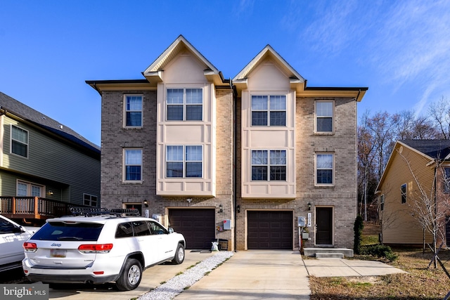 townhome / multi-family property featuring brick siding, driveway, and an attached garage