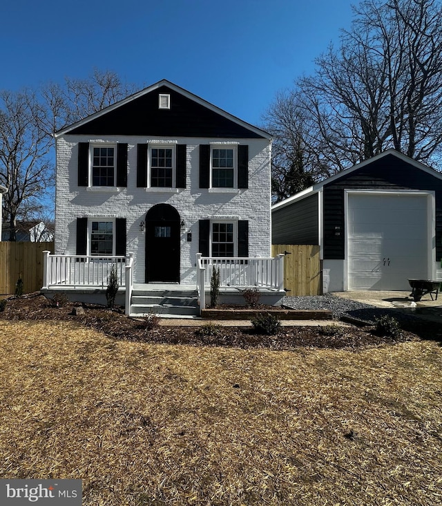 view of front of property featuring a porch, an outbuilding, and fence