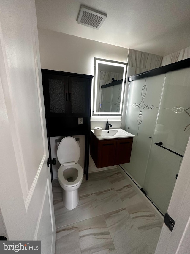 bathroom featuring marble finish floor, vanity, a shower stall, and visible vents