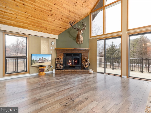 unfurnished living room with high vaulted ceiling, wood finished floors, wood ceiling, baseboards, and a brick fireplace