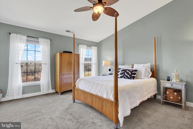 bedroom featuring vaulted ceiling, multiple windows, visible vents, and carpet floors